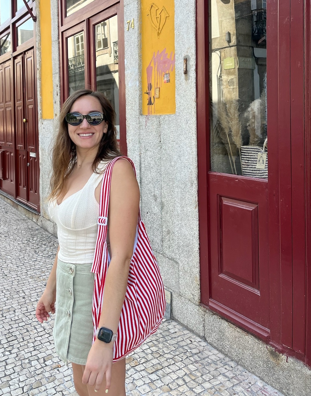 Emily wearing the finished red and white striped Billy Bag on a street in Porto, Portugal